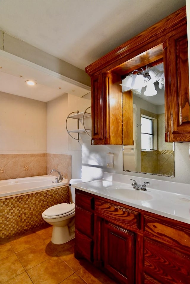 full bath featuring toilet, tile patterned flooring, tiled bath, and vanity