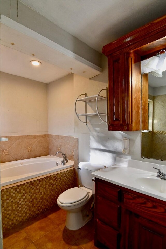 bathroom featuring vanity, toilet, tile patterned flooring, and a garden tub