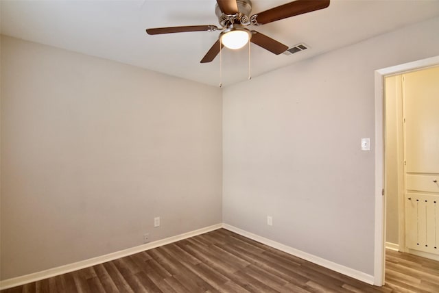 spare room with visible vents, baseboards, a ceiling fan, and wood finished floors