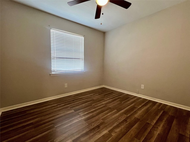 empty room featuring dark wood-style flooring, baseboards, and ceiling fan