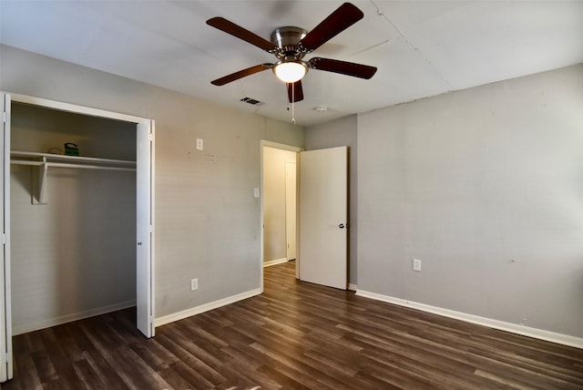 unfurnished bedroom featuring a closet, visible vents, baseboards, and wood finished floors