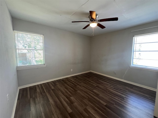 spare room featuring ceiling fan, baseboards, and wood finished floors