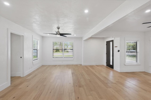 unfurnished living room with ceiling fan, light wood-style floors, plenty of natural light, recessed lighting, and baseboards