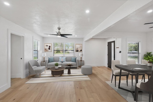 living room featuring a ceiling fan, healthy amount of natural light, baseboards, light wood-type flooring, and recessed lighting