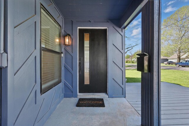 entrance to property with a lawn