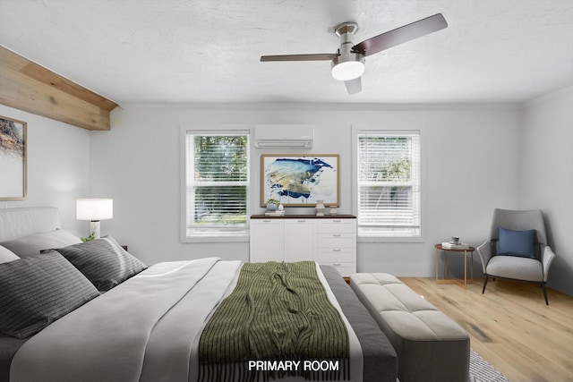 bedroom featuring an AC wall unit, light wood-style flooring, multiple windows, crown molding, and a ceiling fan