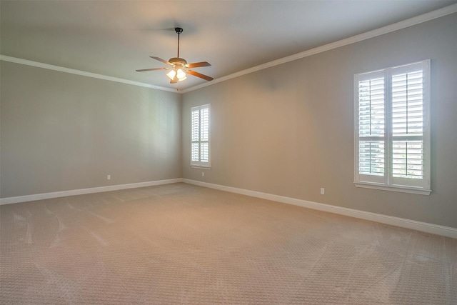 unfurnished room with crown molding, ceiling fan, light colored carpet, and baseboards
