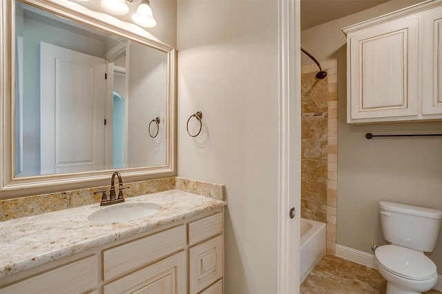 bathroom featuring bathing tub / shower combination, toilet, vanity, and baseboards