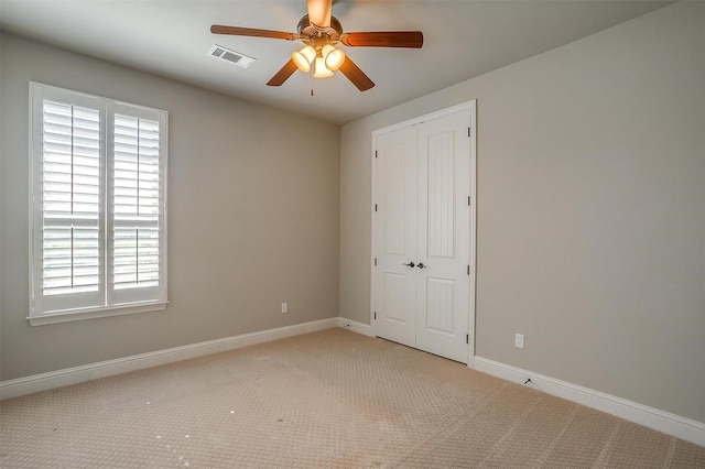 unfurnished room featuring visible vents, ceiling fan, carpet flooring, and baseboards