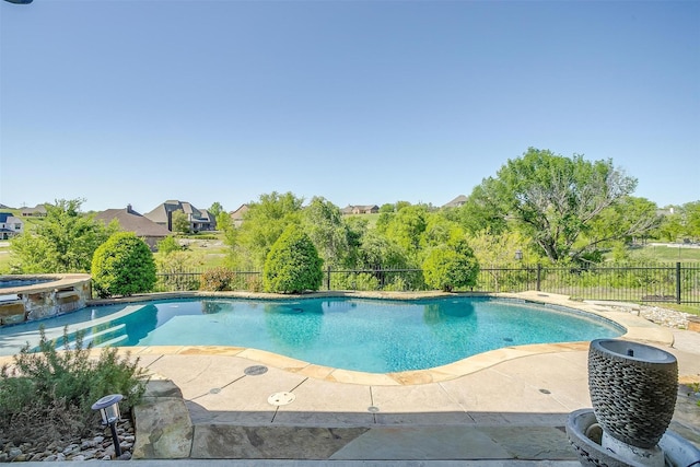 view of pool featuring a patio area, a fenced backyard, and a pool with connected hot tub