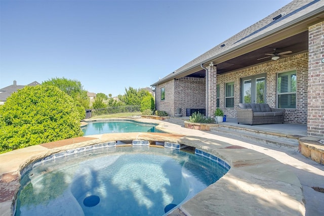 view of swimming pool with a fenced in pool, a patio, an in ground hot tub, and ceiling fan