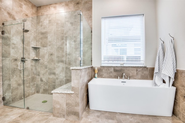 1765 Bramshaw Trl, Farmers Branch, TX 75234 - bathroom with tile walls, a shower stall, and a freestanding bath