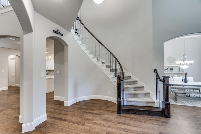 1765 Bramshaw Trl, Farmers Branch, TX 75234 - foyer with stairs, wood finished floors, arched walkways, and a chandelier