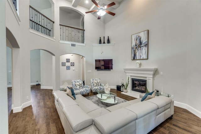 1765 Bramshaw Trl, Farmers Branch, TX 75234 - living room with wood finished floors, visible vents, a ceiling fan, arched walkways, and a glass covered fireplace