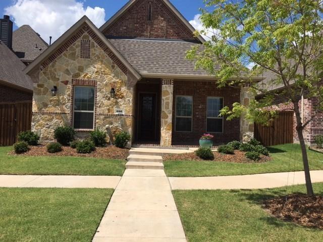 686 Pendle Forest Dr, Frisco, TX 75036 - view of front of property with stone siding, a front yard, brick siding, fence, and a shingled roof