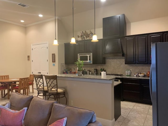 686 Pendle Forest Dr, Frisco, TX 75036 - kitchen with visible vents, appliances with stainless steel finishes, pendant lighting, custom range hood, and backsplash