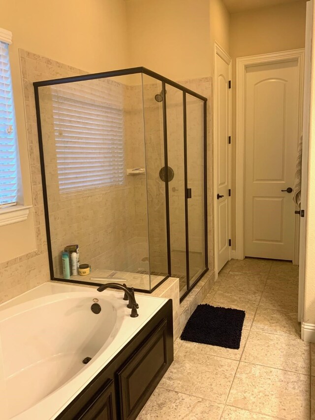 686 Pendle Forest Dr, Frisco, TX 75036 - bathroom featuring tile patterned flooring, a bath, and a stall shower