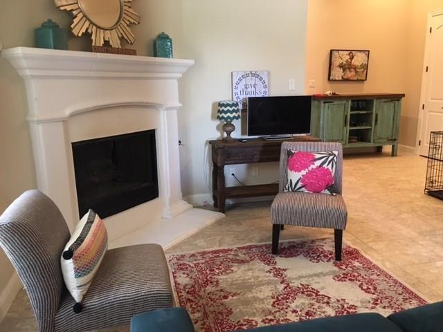 686 Pendle Forest Dr, Frisco, TX 75036 - living area featuring baseboards and a fireplace
