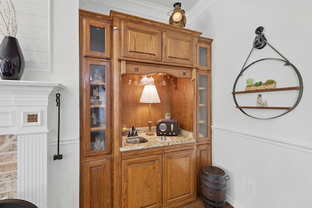 interior space with a sink and crown molding