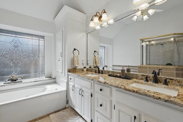 full bathroom with a sink, a tile shower, a garden tub, and lofted ceiling