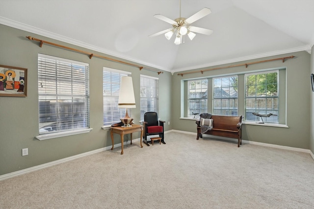 sitting room with baseboards, ornamental molding, a ceiling fan, lofted ceiling, and carpet