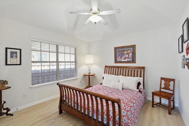 bedroom featuring baseboards, a ceiling fan, and wood finished floors