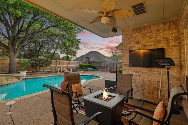 view of pool featuring a fenced in pool, a patio area, a fenced backyard, an outdoor fire pit, and ceiling fan