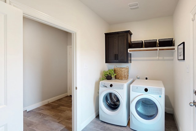 1421 Sage Way, Little Elm, TX 76227 - laundry room featuring separate washer and dryer, light wood-style floors, and cabinet space