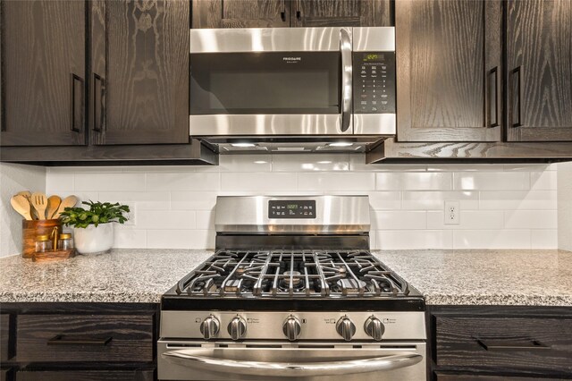 1421 Sage Way, Little Elm, TX 76227 - kitchen featuring stainless steel appliances, dark brown cabinetry, light countertops, and tasteful backsplash