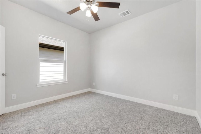 unfurnished room with baseboards, a ceiling fan, visible vents, and carpet floors