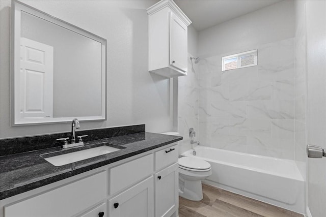 bathroom with toilet, wood finished floors, bathing tub / shower combination, and vanity