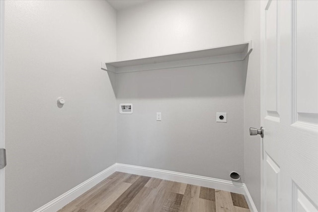 laundry room featuring laundry area, hookup for a washing machine, wood finished floors, hookup for an electric dryer, and baseboards