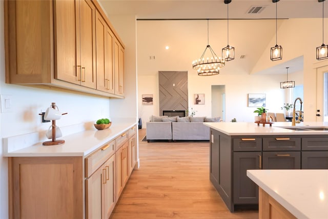 kitchen with visible vents, light countertops, and a sink