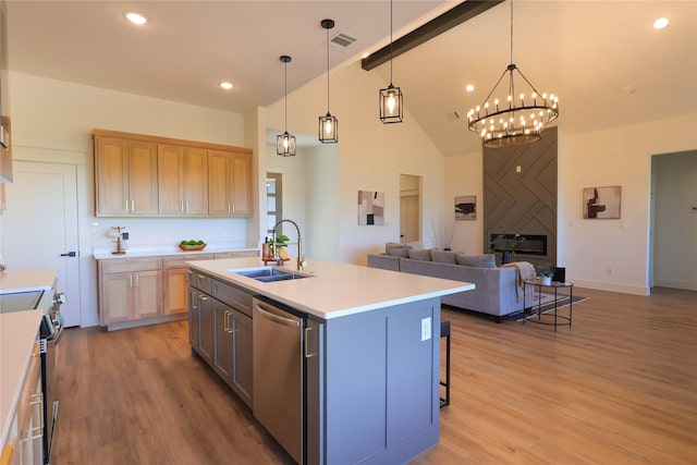 kitchen with an inviting chandelier, open floor plan, visible vents, appliances with stainless steel finishes, and a sink