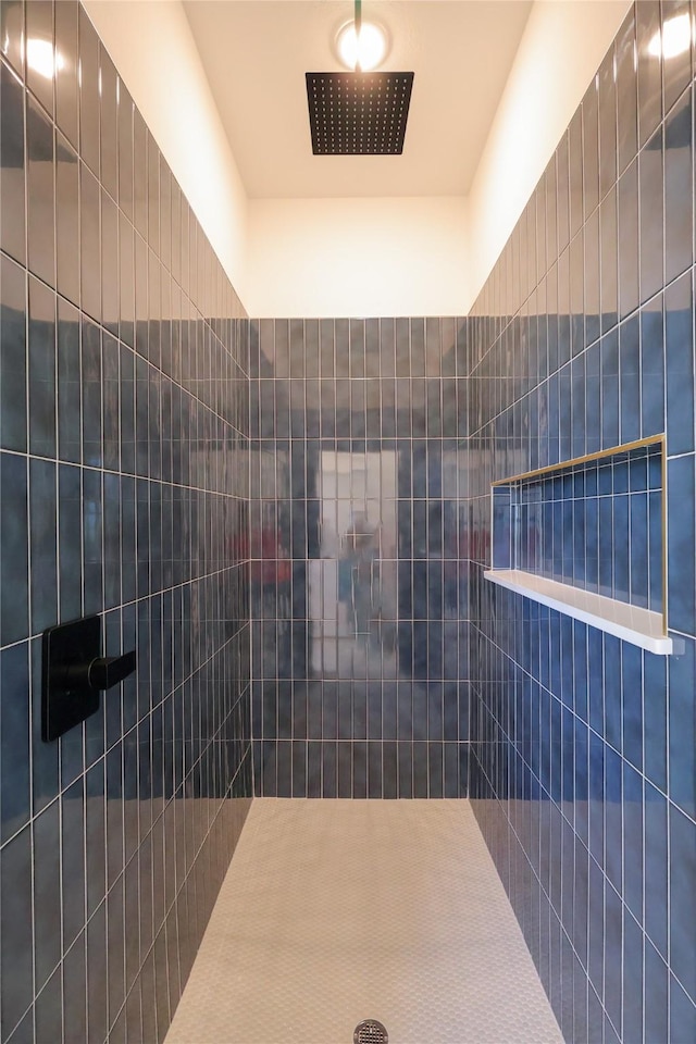full bath featuring a tile shower
