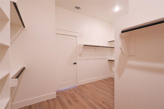 spacious closet featuring visible vents and light wood-type flooring