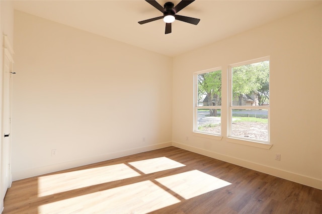 unfurnished room featuring baseboards, ceiling fan, and wood finished floors