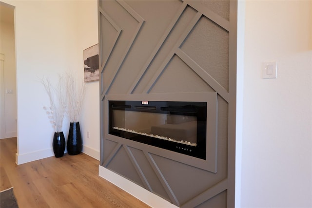 room details featuring baseboards and wood finished floors