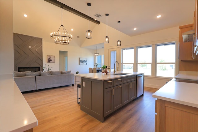 kitchen featuring visible vents, a sink, light countertops, gray cabinetry, and stainless steel dishwasher