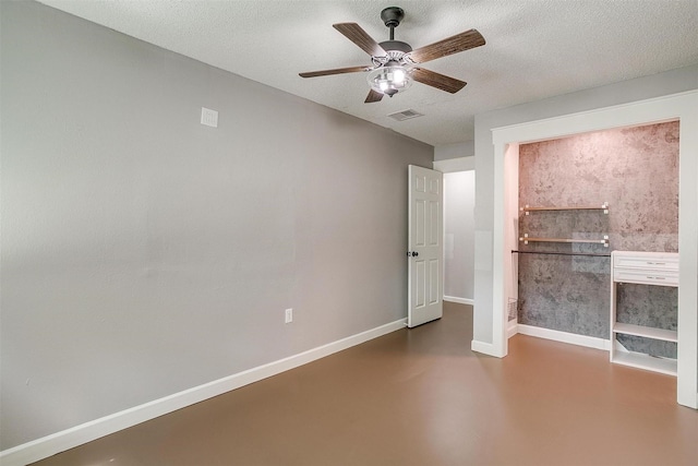 603 S 2nd St, Midlothian, TX 76065 - unfurnished bedroom with finished concrete floors, baseboards, ceiling fan, and a textured ceiling