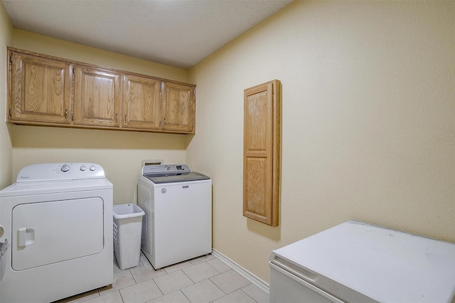 603 S 2nd St, Midlothian, TX 76065 - washroom featuring washer and dryer, cabinet space, baseboards, and light tile patterned floors