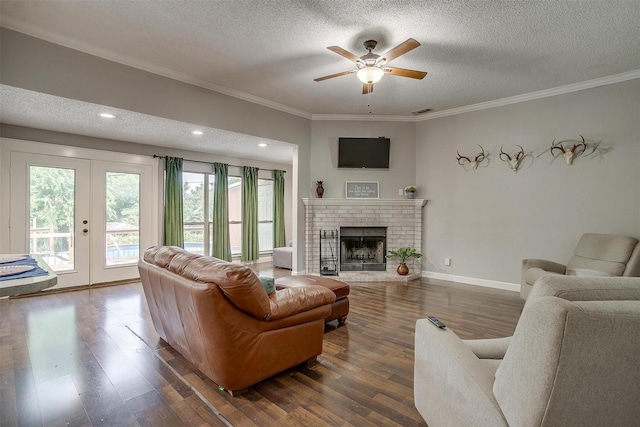 603 S 2nd St, Midlothian, TX 76065 - living room featuring a textured ceiling, french doors, ornamental molding, dark wood-style floors, and a ceiling fan