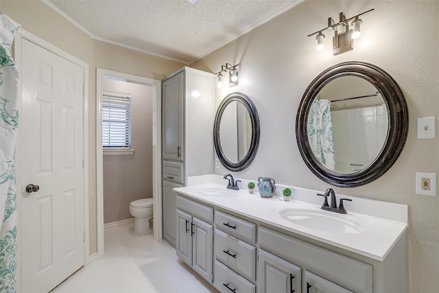 603 S 2nd St, Midlothian, TX 76065 - bathroom with a textured ceiling, double vanity, toilet, crown molding, and tile patterned flooring