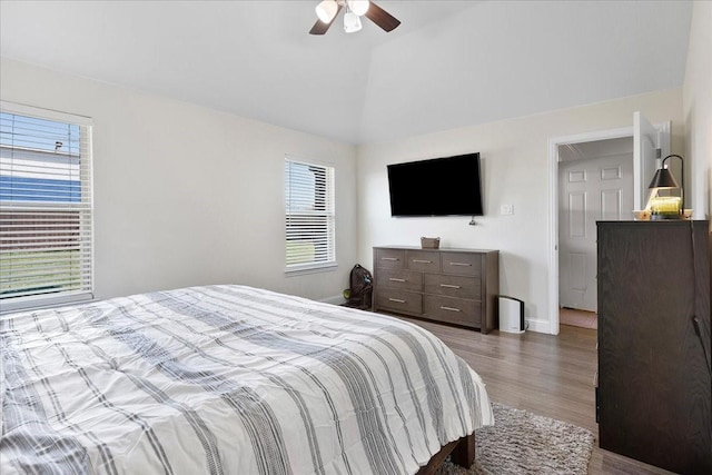 303 W Ohio Ave, Dallas, TX 75224 - bedroom with ceiling fan, baseboards, vaulted ceiling, and wood finished floors