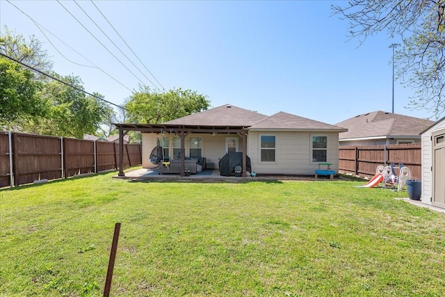 303 W Ohio Ave, Dallas, TX 75224 - back of property featuring a yard, a patio area, and a fenced backyard