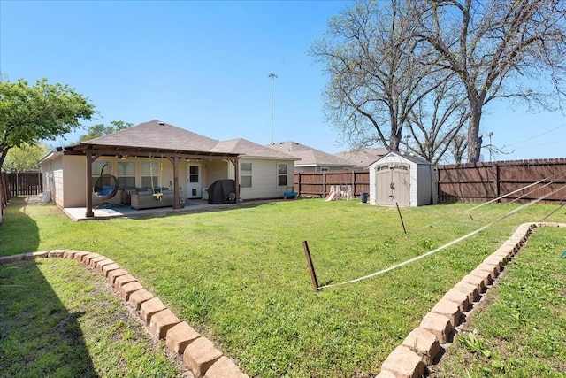 303 W Ohio Ave, Dallas, TX 75224 - view of yard featuring a patio, an outbuilding, a shed, and a fenced backyard