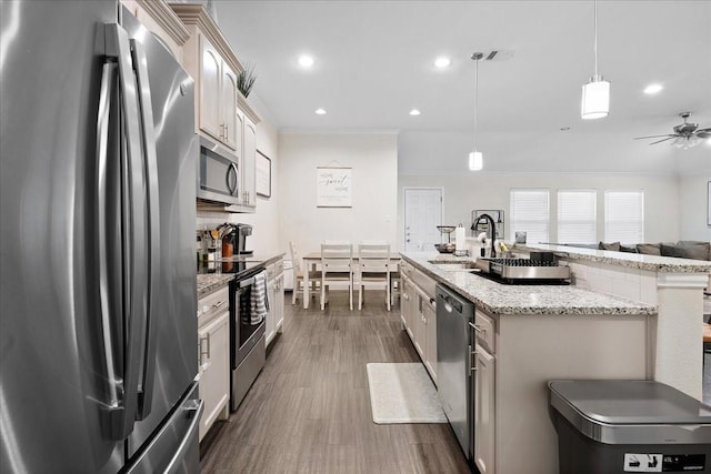 303 W Ohio Ave, Dallas, TX 75224 - kitchen featuring dark wood-style flooring, crown molding, visible vents, stainless steel appliances, and a sink