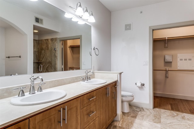 3818 Holland Ave Unit 305, Dallas, TX 75219 - full bathroom featuring a walk in closet, a stall shower, a sink, and visible vents