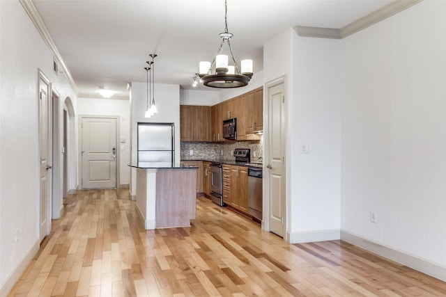 3818 Holland Ave Unit 305, Dallas, TX 75219 - kitchen with an inviting chandelier, tasteful backsplash, light wood-type flooring, dark countertops, and stainless steel appliances