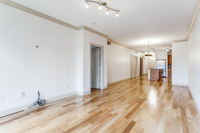 3818 Holland Ave Unit 305, Dallas, TX 75219 - unfurnished living room with a notable chandelier, baseboards, crown molding, visible vents, and light wood finished floors
